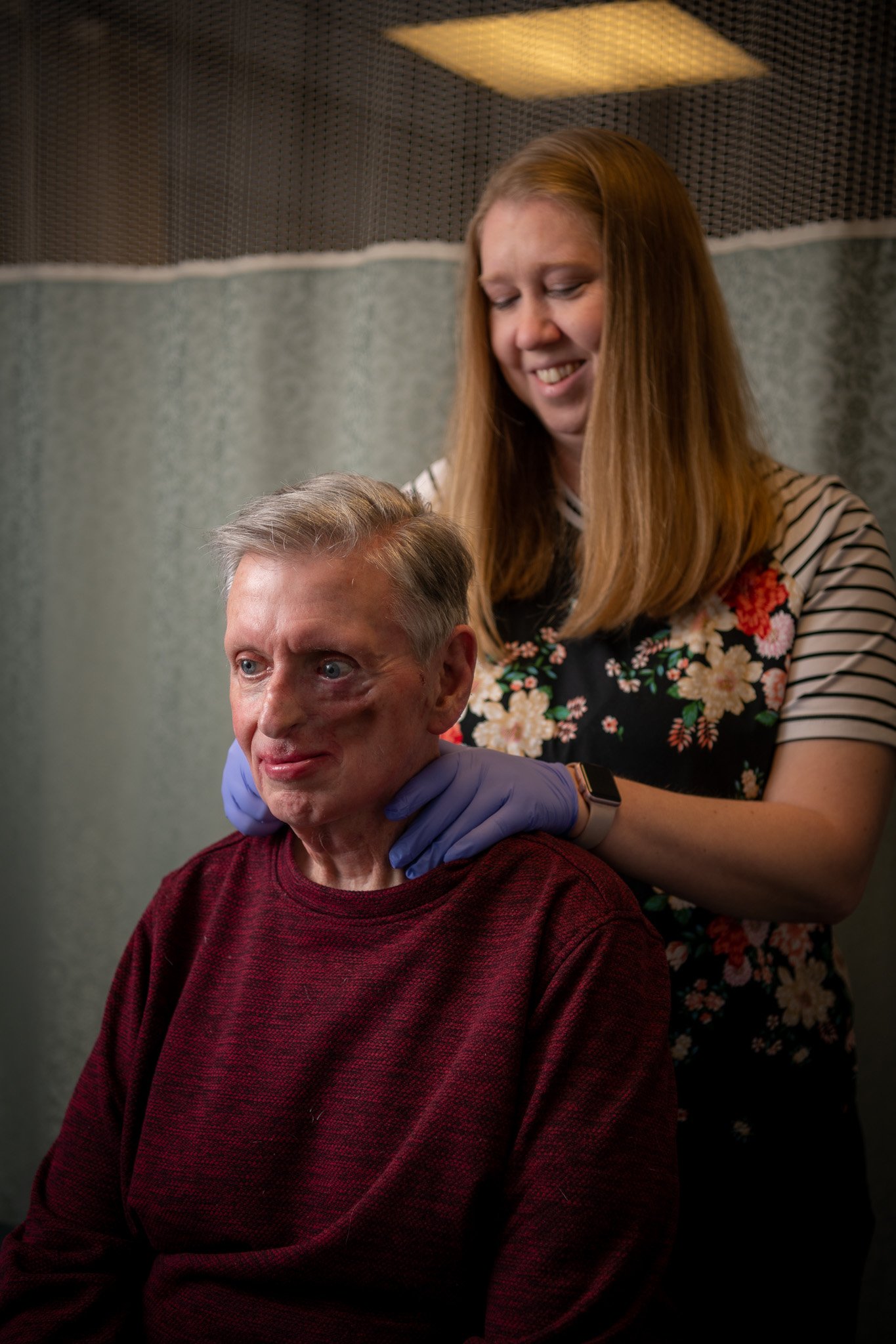 Mary Greeley speech pathologist Emily Fecht demonstrates a massage technique on Bill Roth. The technique helps head and neck cancer patients avoid harmful build-up of lymphatic fluid.