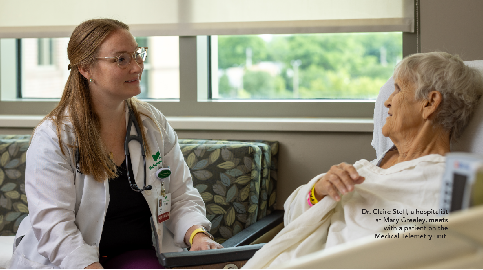 Dr. Claire Stefl, a hospitalist at Mary Greeley, meets with a patient on the Medical Telemetry unit.