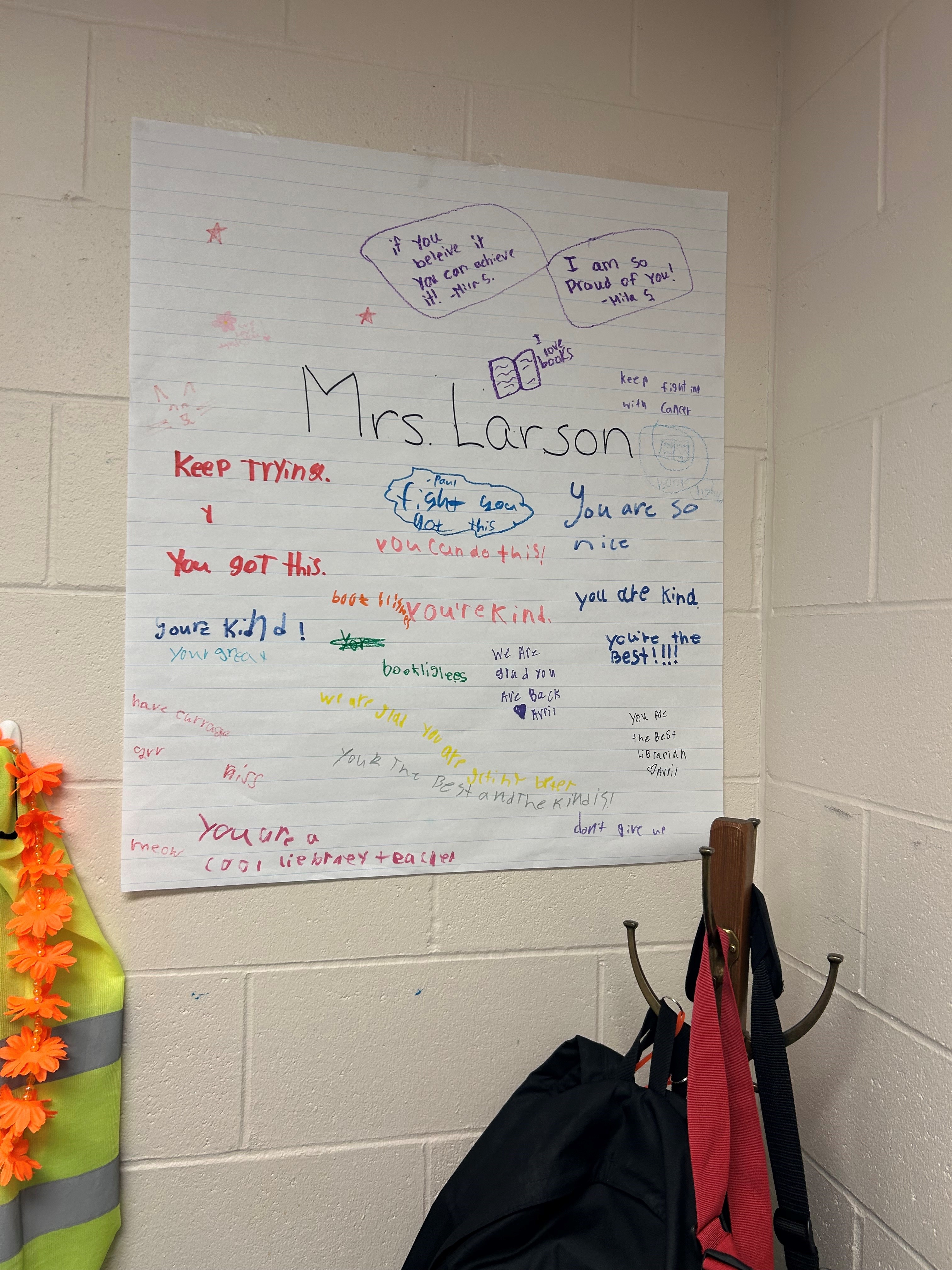 An encouraging poster made by Larson’s students hangs in the library. If you look in the lower left corner, you will see the word “currage,” which inspired the headline for this story.