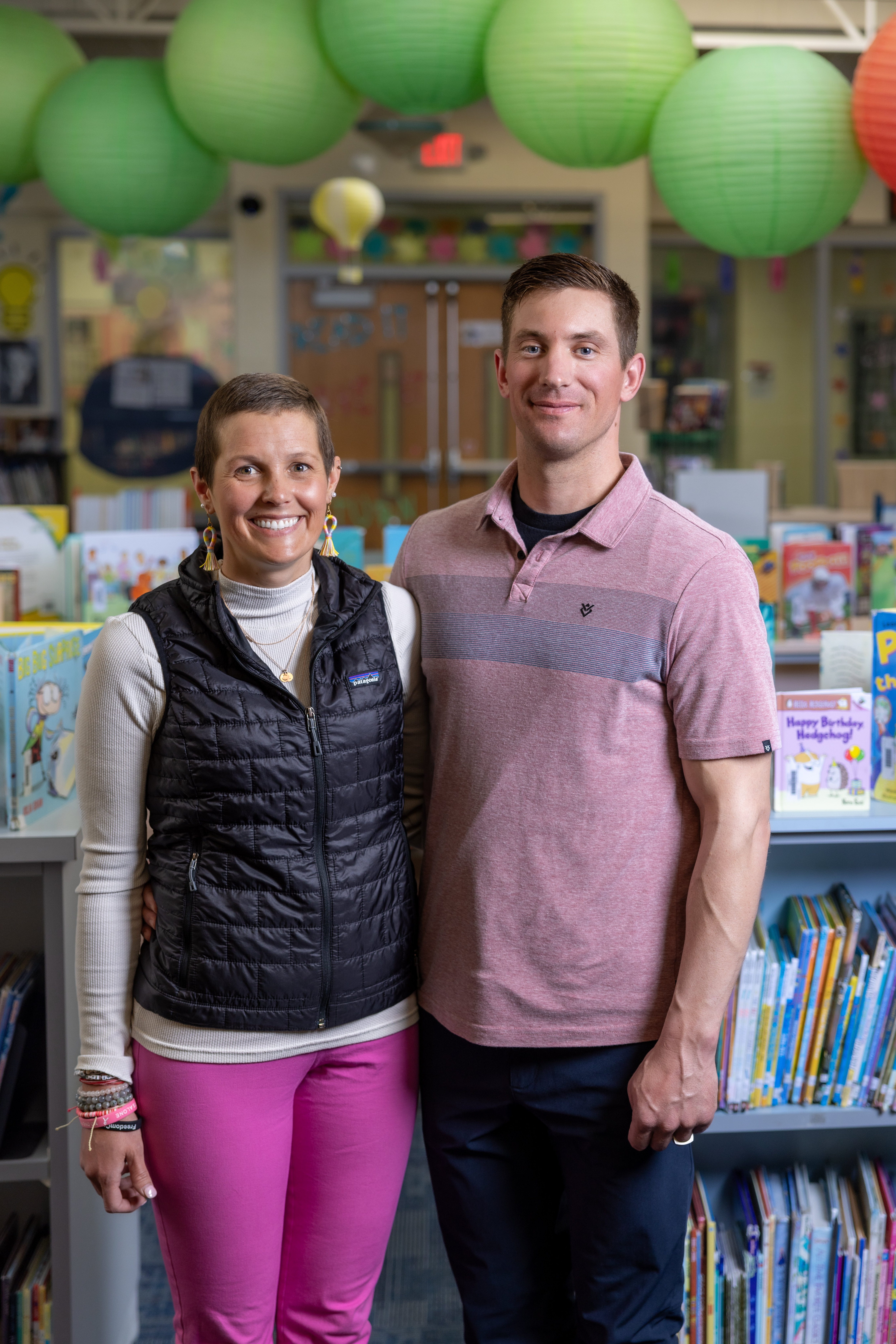 Haily Larson and her husband, Mitch, in the Greene County Elementary school library where Haily works. 