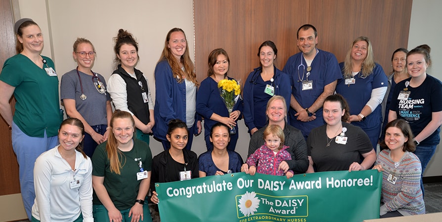 DAISY Award Winners surrounded by their coworkers